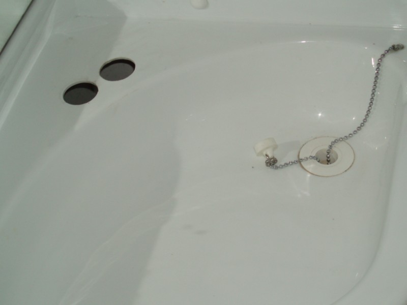 Le trou de gauche là où passe la douchette et à droite le robinet